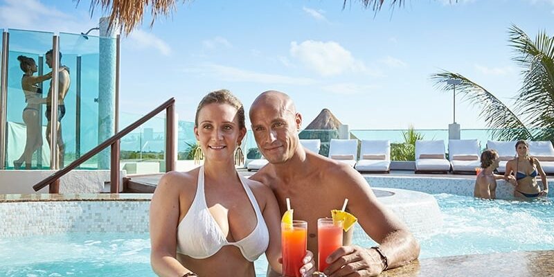 desire-riviera-couple-jacuzzi-drinking-3